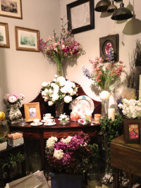 Mueble en esquina con vajilla y decoración floral